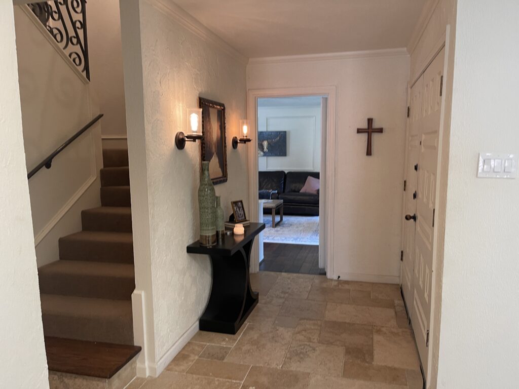 before image of a tired entry way with thick plaster on the walls.