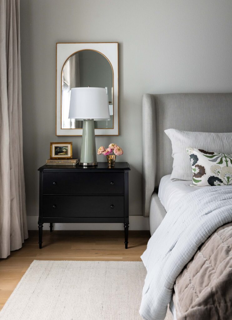 Arched mirror behind black nightstand Dallas Designer Ryan