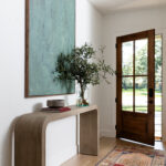 Modern, exaggerated art in the entry of a richardson, tx new build home designed by elizabeth ryan interiors