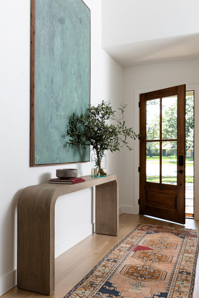 Modern, exaggerated art in the entry of a richardson, tx new build home designed by elizabeth ryan interiors