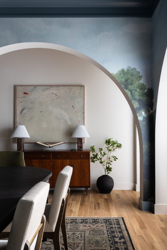 A client's heirloom sideboard styled beneath an arched doorway, bringing family history into a custom new build
